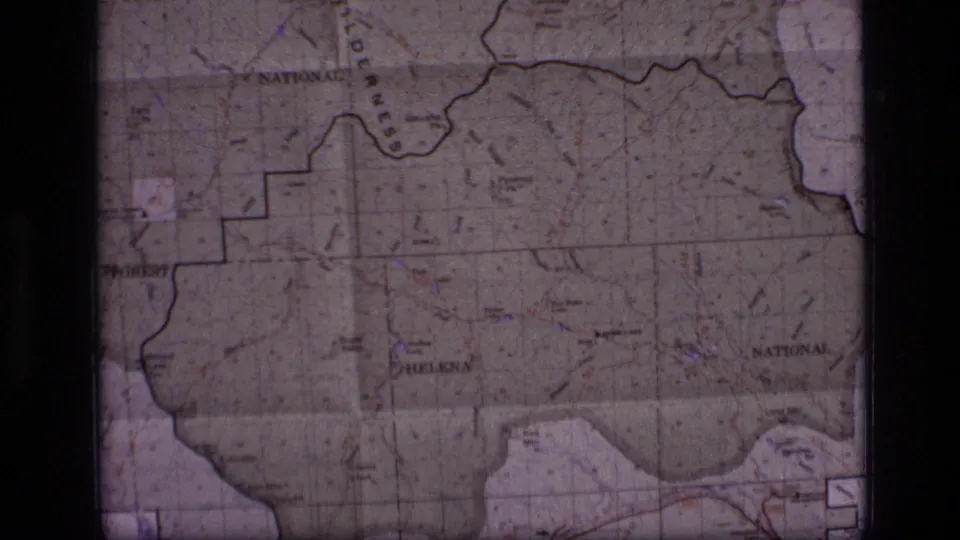 Wider 1973 8mm view of the Scapegoat Wilderness area map with printed boundaries, labels, and visible film gate shadows.