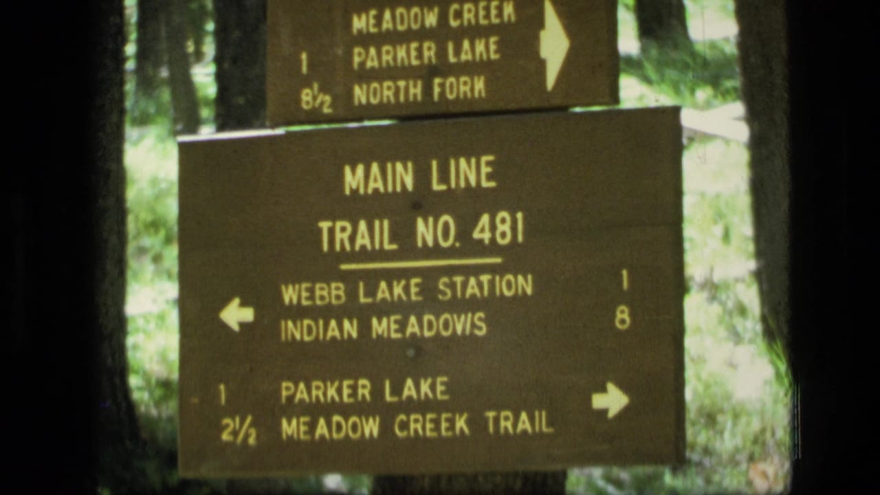 1973 Montana wilderness trail sign pointing toward Webb Lake Station, Indian Meadows, Parker Lake, and Meadow Creek Trail.