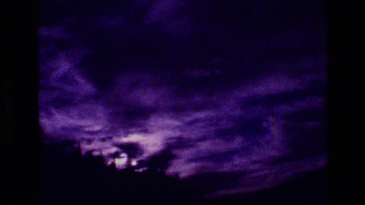 Purple-shifted 8mm view of clouded sky and treeline in the Scapegoat Wilderness area.