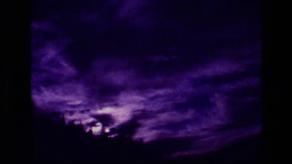 Purple-shifted 8mm view of clouded sky and treeline in the Scapegoat Wilderness area.