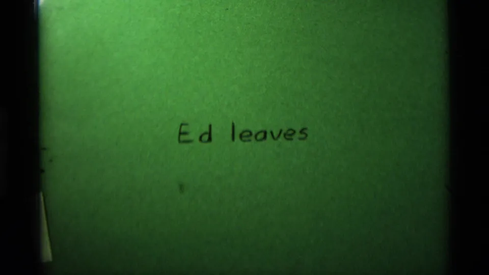 1975 8mm home-movie title card with handwritten text reading Ed leaves, tinted green with visible film borders.