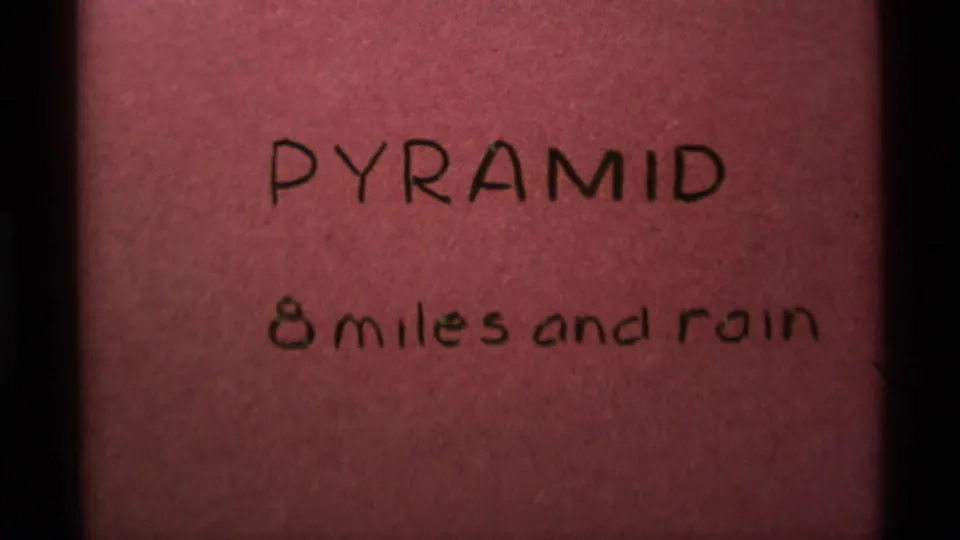 Handwritten 8mm title card from the Montana reel reading "PYRAMID 8 miles and rain."