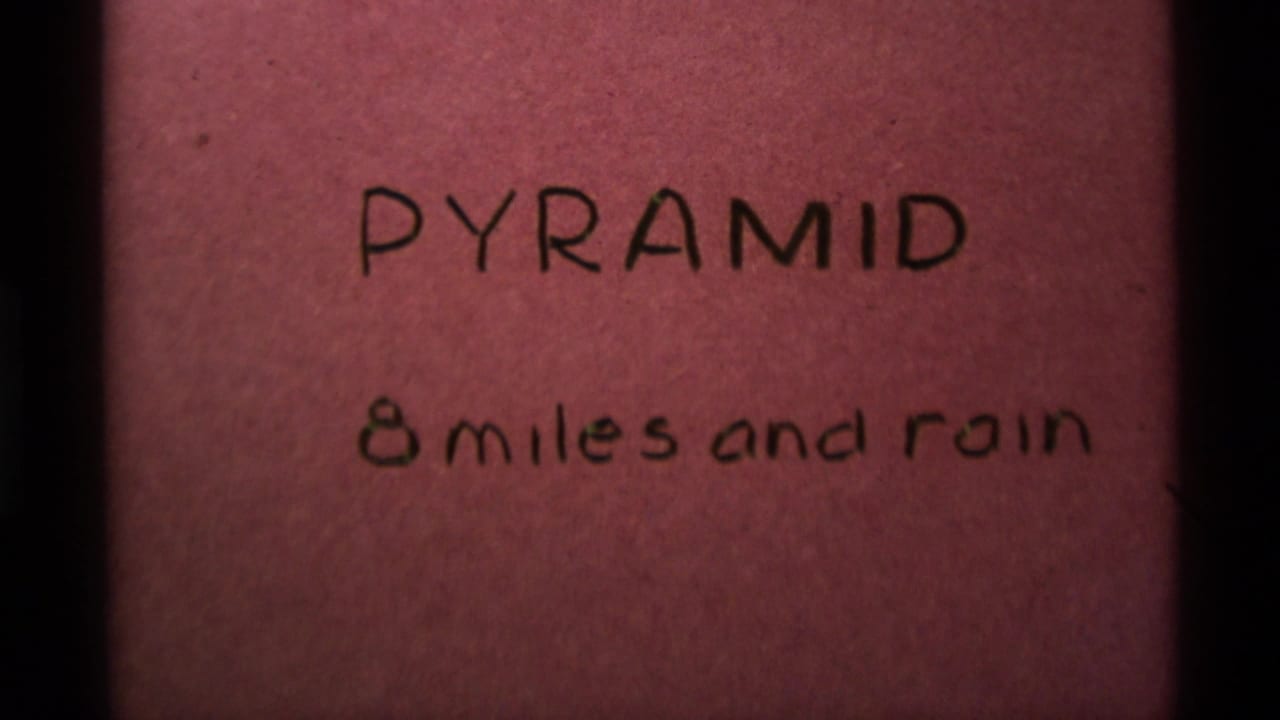Handwritten title card on pink paper reading Pyramid and 8 miles and rain.