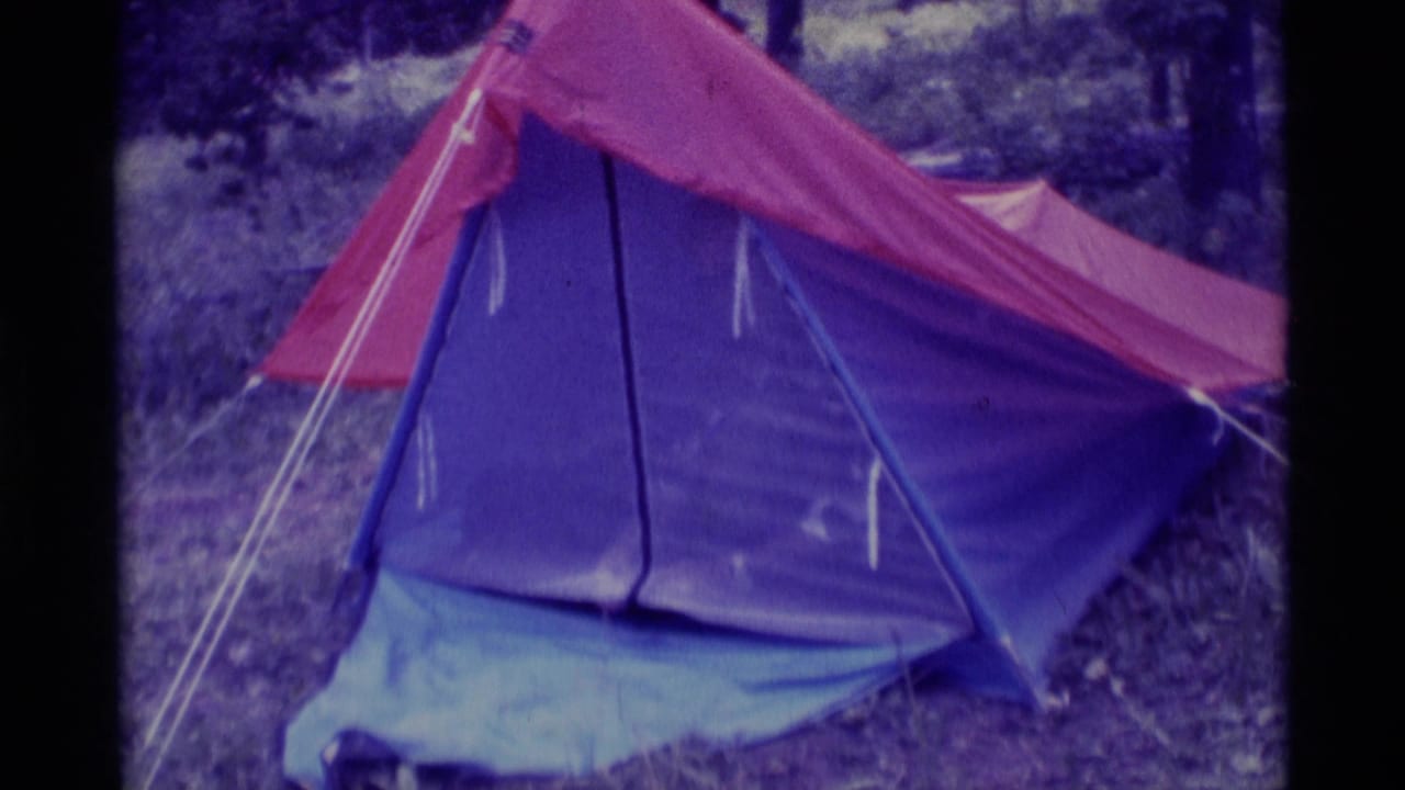 Tent entrance remains mostly closed with red fly and blue panels.