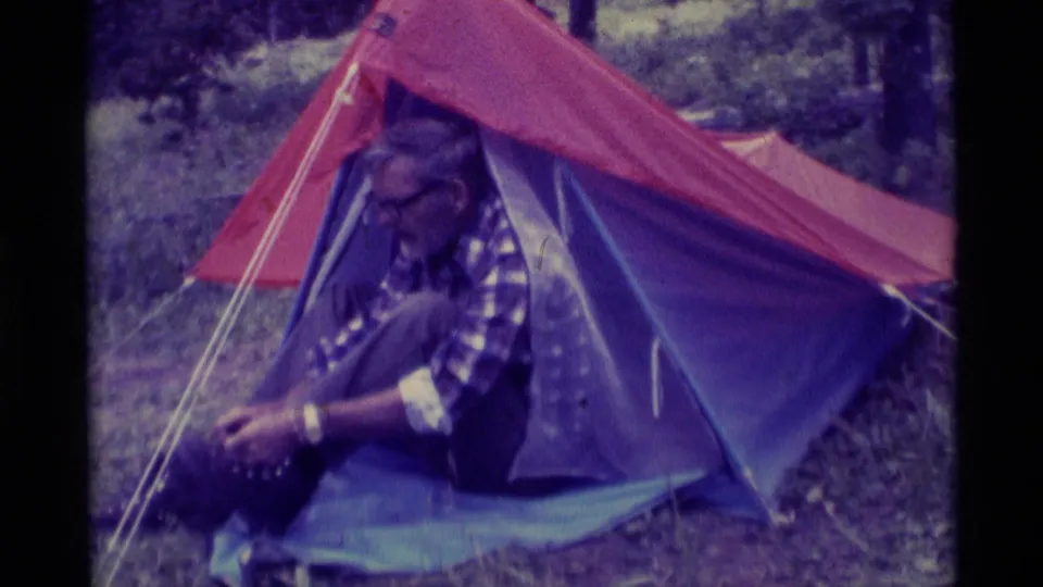 The final frame shows the older man at the Agate Springs tent entrance, head lowered as he continues securing his boot.