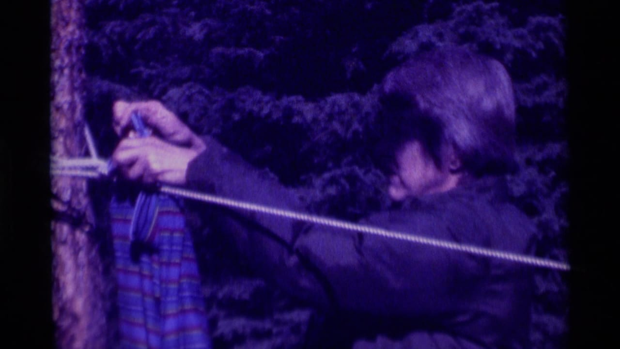 A close view shows a person fastening a striped wet garment to a clothesline in the Agate Springs backyard scene.