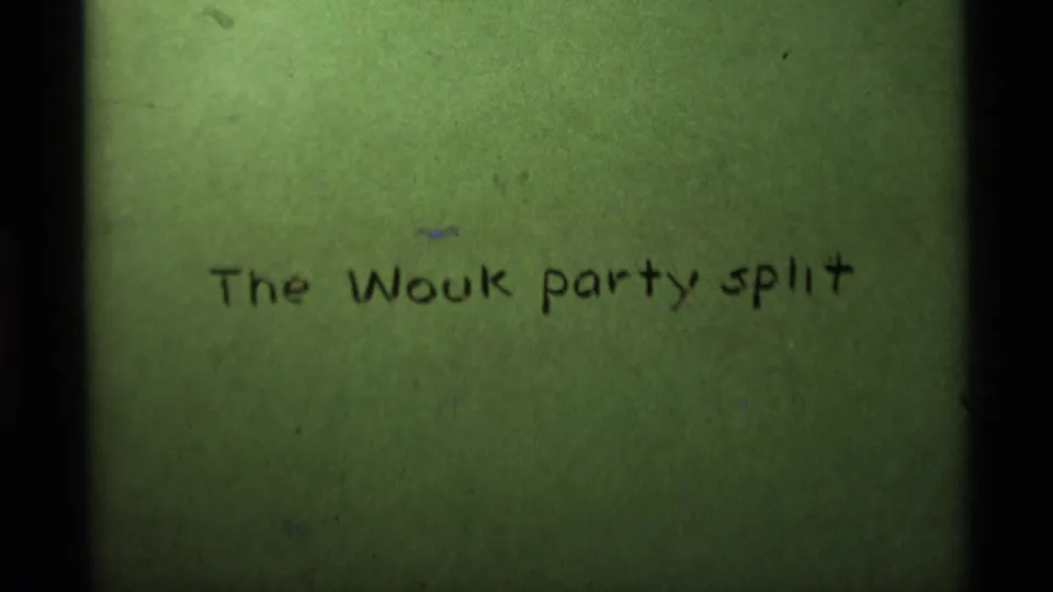 A green 8mm title card fills the frame with handwritten black text reading The Wouk party split.