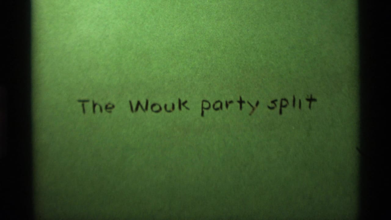 1975 8mm home-movie title card reading The Wouk party split, photographed on green film leader.