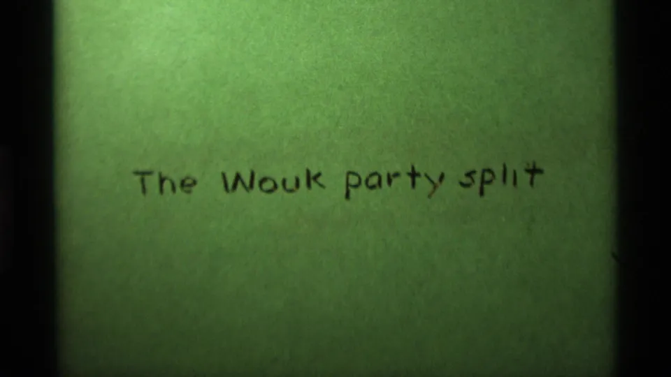 1975 8mm home-movie title card reading The Wouk party split, photographed on green film leader.