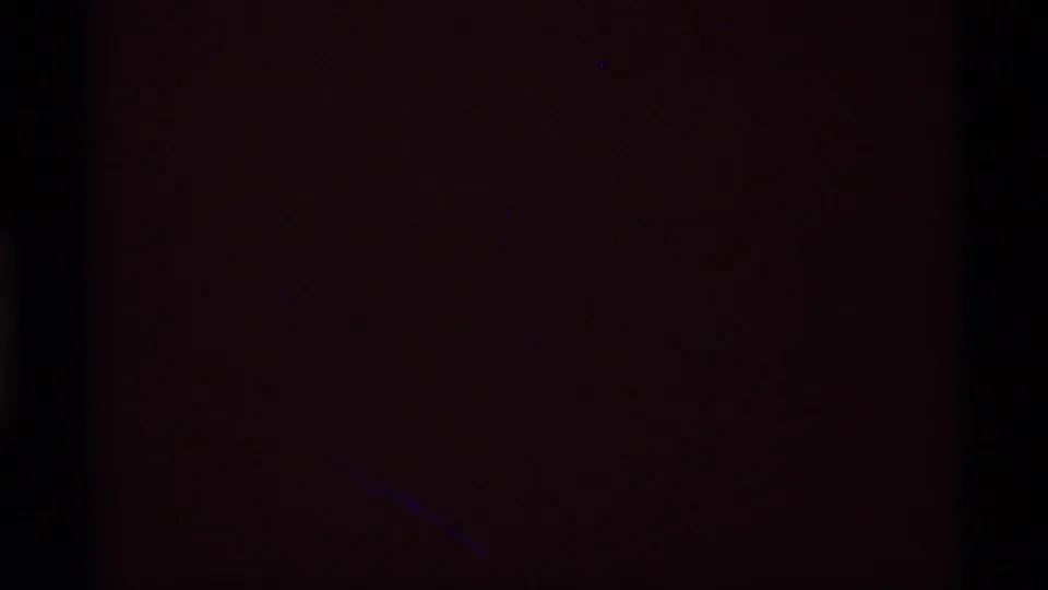 End frame from the 1975 8mm clip appears mostly dark reddish, likely during a transition or exposure change, with no clear subject visible.