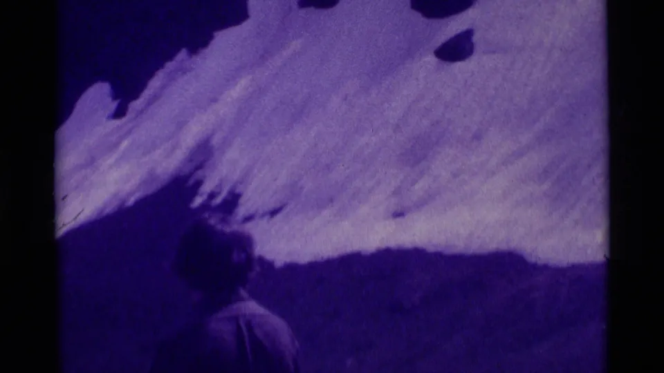 1975 Agate Springs, Montana hiking footage with a snowy slope and a partially visible hiker near the lower edge.