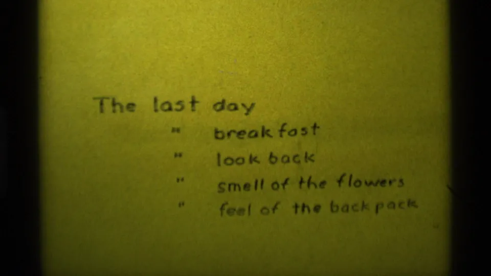 1975 Agate Springs 8mm frame showing yellow paper titled “The last day” with handwritten prompts including breakfast and looking back.