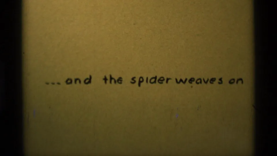 1975 8mm frame from Agate Springs with the handwritten spider phrase repeated on warm aged paper.