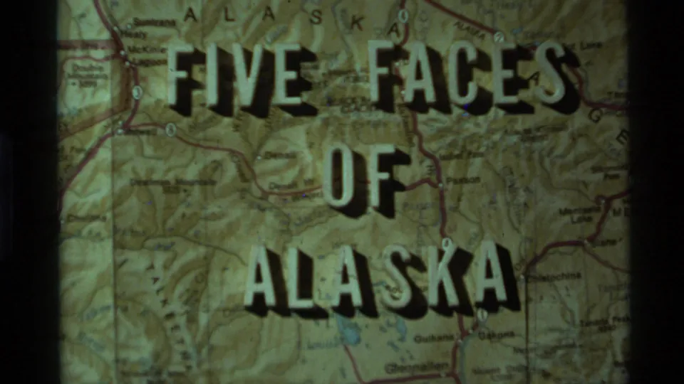 Late clip frame showing the Five Faces of Alaska title on a projected Alaska map with green-yellow color shift and film grain.