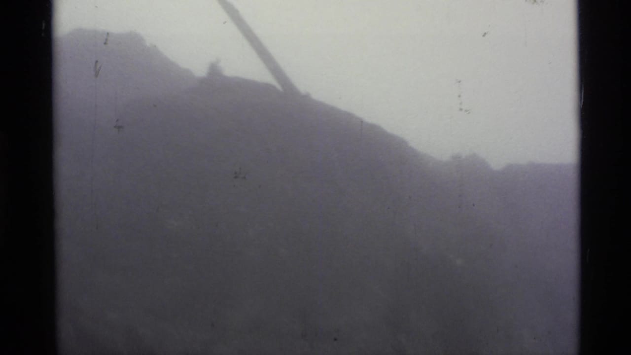 Foggy mountain slope seen through soft 8mm frame edges.