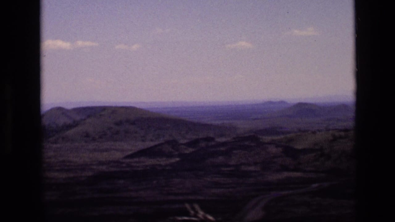 1972 Idaho 8mm frame with broad rolling terrain, a low horizon, and distant hills softened by faded home-movie color.