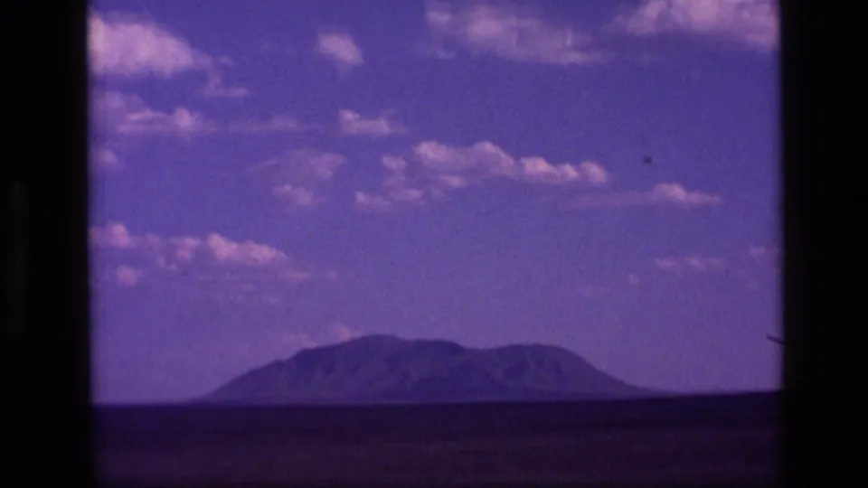 1972 Idaho 8mm scenic frame showing a low mountain range on the horizon with visible film aging and color shift.