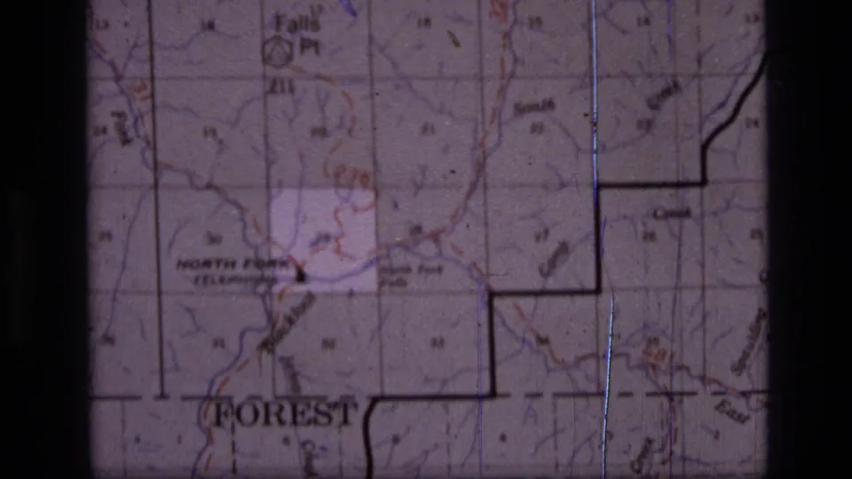 Final 1973 8mm map view showing labeled terrain, grid squares, a wilderness boundary line and scratches from the film scan.