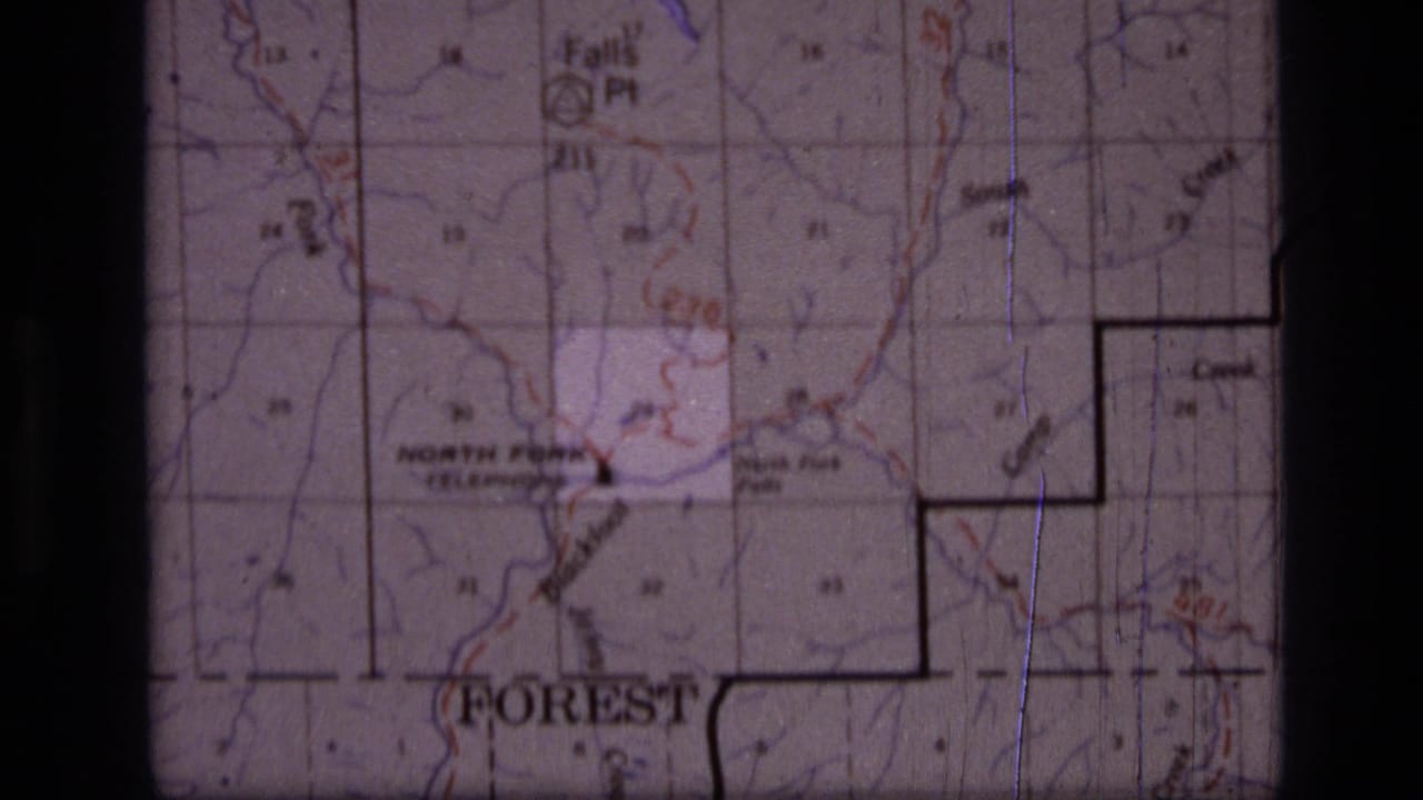 1973 8mm frame of a Scapegoat Wilderness, Montana map showing grid lines, North Fork labeling, contour marks, and dark film borders.