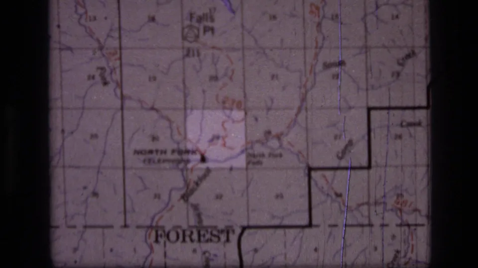 1973 8mm frame of a Scapegoat Wilderness, Montana map showing grid lines, North Fork labeling, contour marks, and dark film borders.
