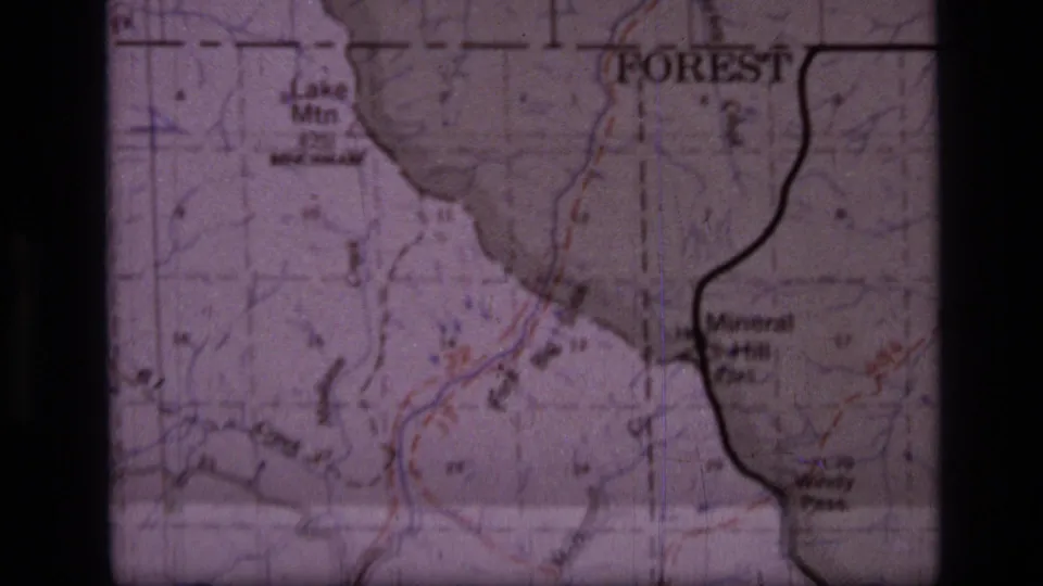 1973 8mm frame of a Scapegoat Wilderness map with Lake Mtn, Mineral Hill, forest text, contour lines, and boundary markings.