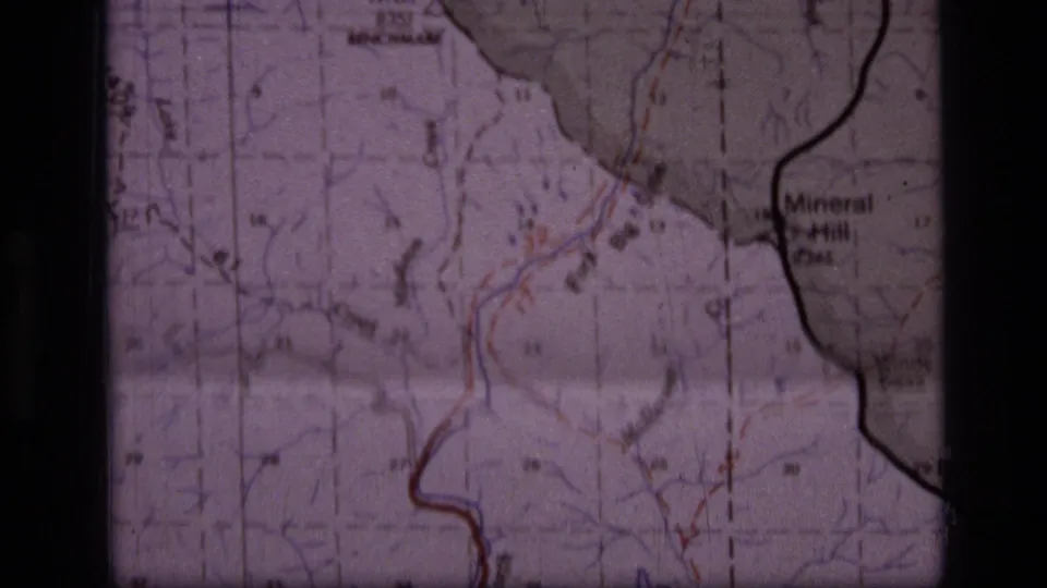 1973 8mm frame of the Montana wilderness map showing Mineral Hill, the Windy Pass area, red route markings, and boundary lines.