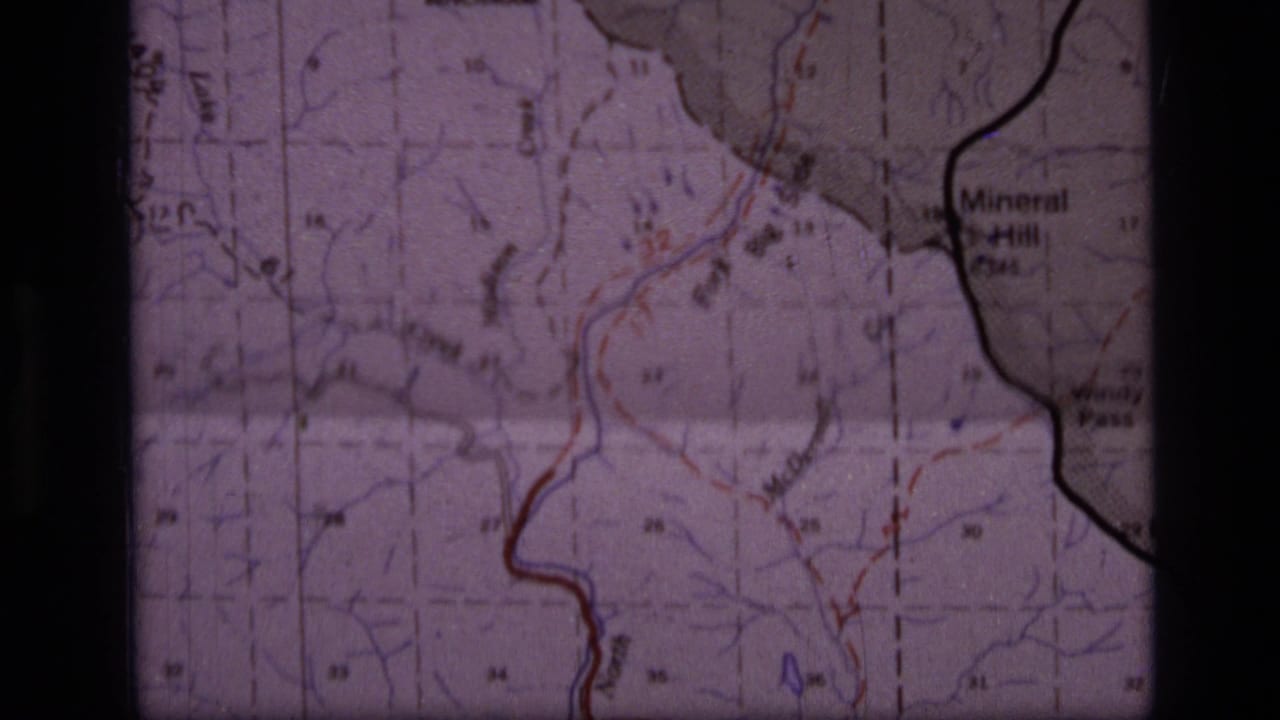 1973 8mm frame showing part of a Scapegoat Wilderness area map with contour lines, red and blue markings, and the Mineral Hill label.
