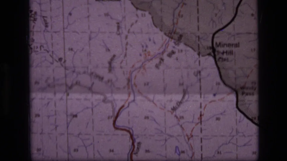 1973 8mm frame showing part of a Scapegoat Wilderness area map with contour lines, red and blue markings, and the Mineral Hill label.