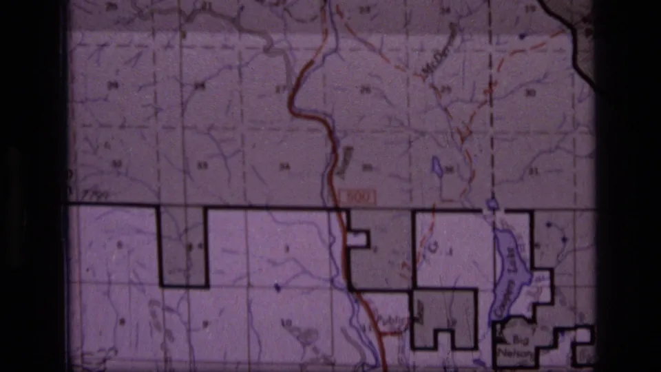 1973 8mm view of the Scapegoat Wilderness map with red route marking, blue water detail, and black boundary blocks.