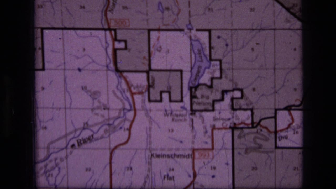Topographic map section showing blue waterways, red lines, black outlines, and printed place names.