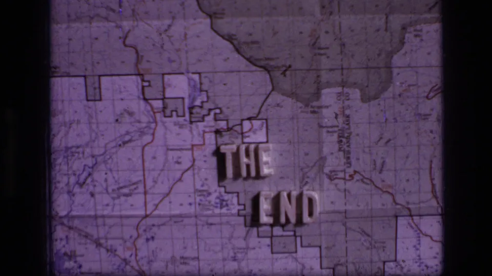 Final 1973 Scapegoat Wilderness closing frame with THE END in raised letters over a purple-tinted topographic map.