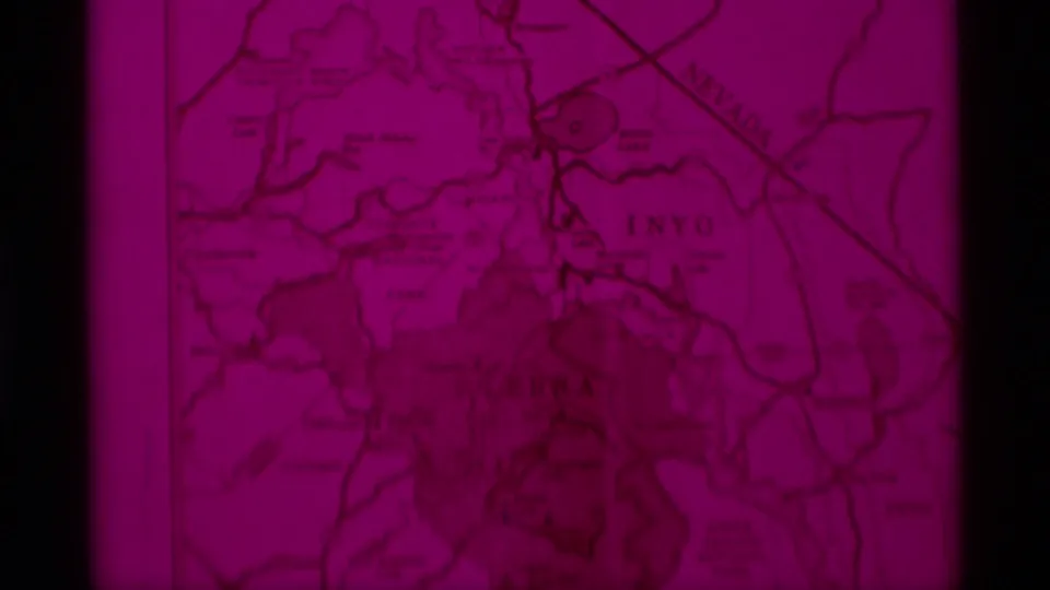 Final 1975 8mm frame holds on the magenta-tinted visitors map, with Inyo visible and printed route lines across the page.