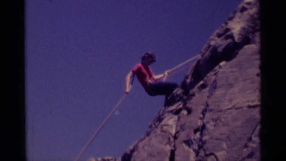 The final frame shows the climber close to the rock, rope taut across the 8mm view, with rugged stone and blue sky behind.