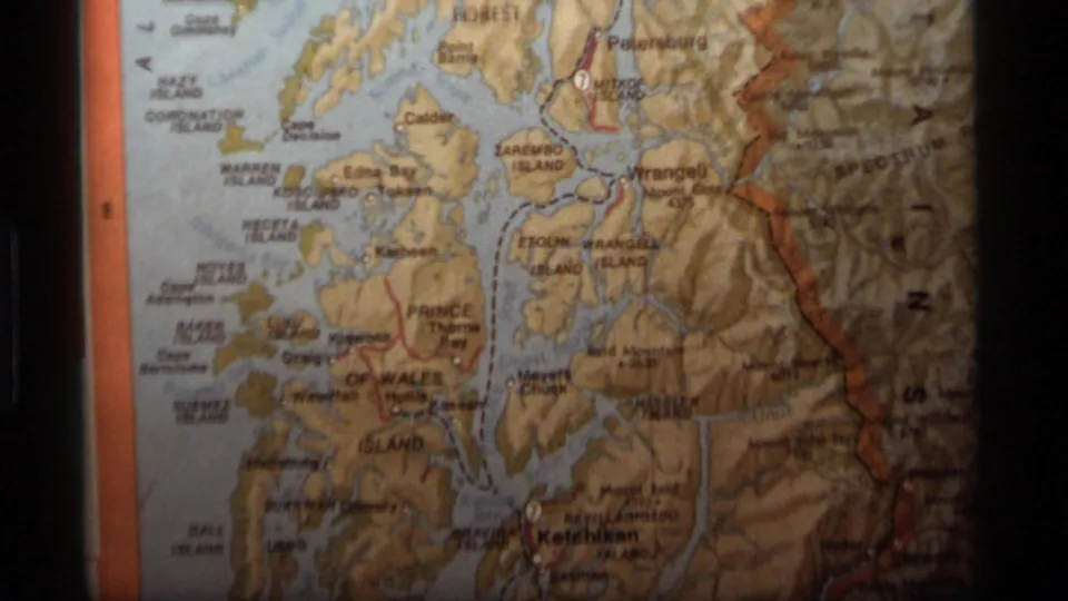 Close 8mm view of an Alaska map section, with Wrangell-area labels, waterways, shaded terrain, and dark frame borders.