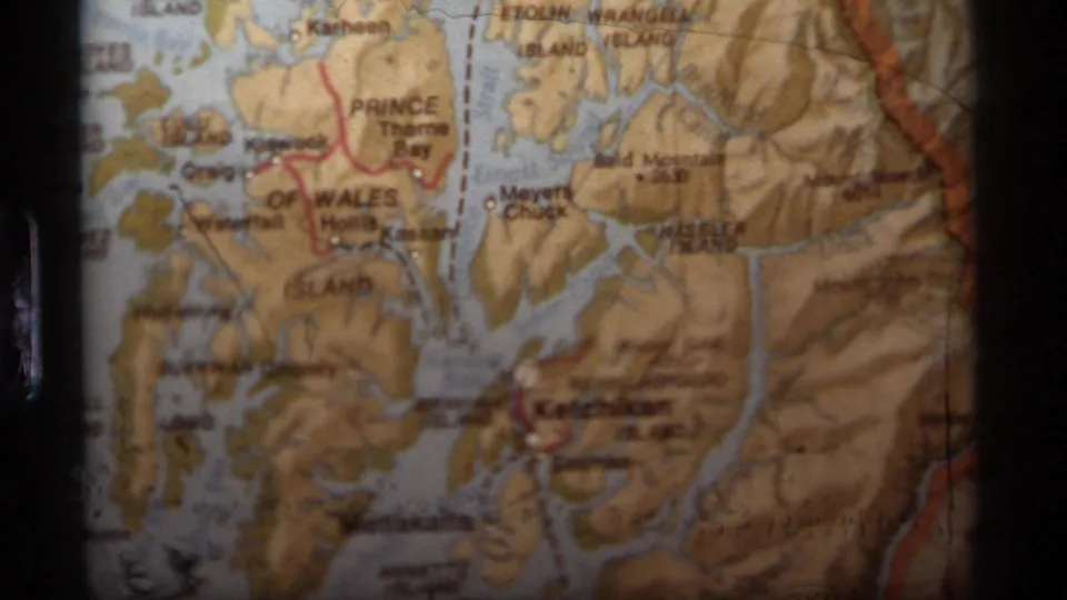 1977 8mm frame of a physical Alaska map focused on Ketchikan, Prince of Wales Island, and nearby coastal channels.