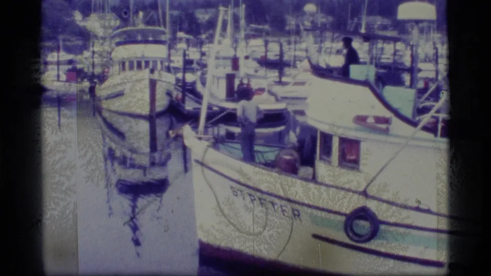 A 1977 Alaska marina view shows docked boats and masts, including a white vessel with STIFTER visible on the hull.