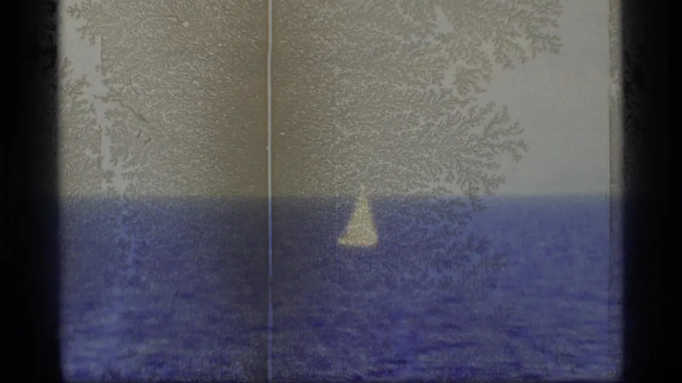 Soft 8mm Alaska maritime frame with a distant white sailboat, blue water, pale sky, and pronounced vertical film wear.