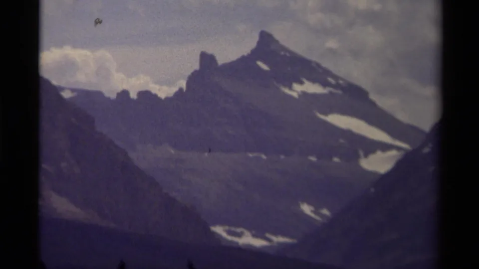 1979 Canada 8mm mountain view with jagged peak, pale snow fields, overcast sky, and visible film wear.