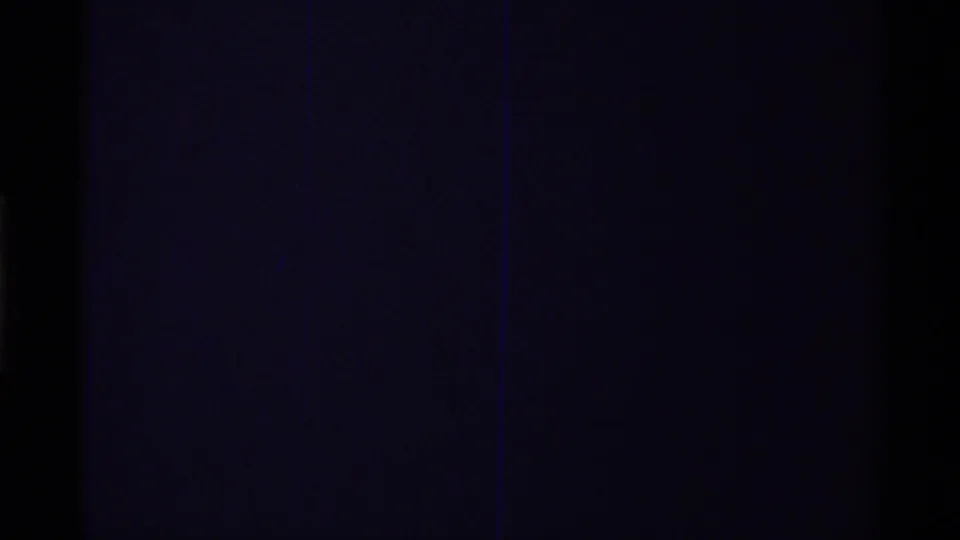 Final 1979 8mm frame from the clip showing near-total image loss with faint blue-purple film tone.
