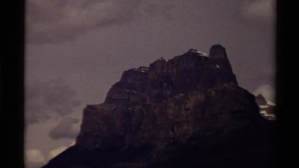 1979 Canadian 8mm frame showing a closer mountain view with darker exposure and clouds behind the peak.