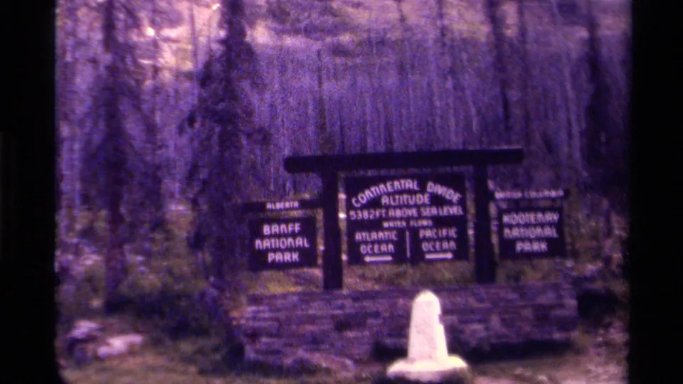 Final 1979 8mm frame of the Continental Divide roadside marker between Banff and Kootenay National Parks.