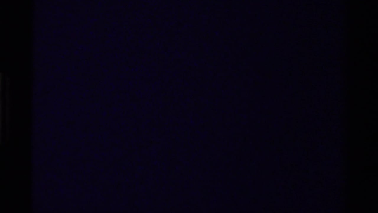 Underexposed 1979 Canada 8mm frame with faint rocky canyon detail and dark film edges.