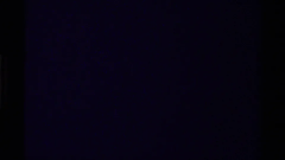 Underexposed 1979 Canada 8mm frame with faint rocky canyon detail and dark film edges.