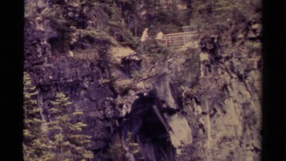 Final 1979 Canada frame shows a rocky, forested canyon with a wooden walkway and distant visitors watching from a railing.