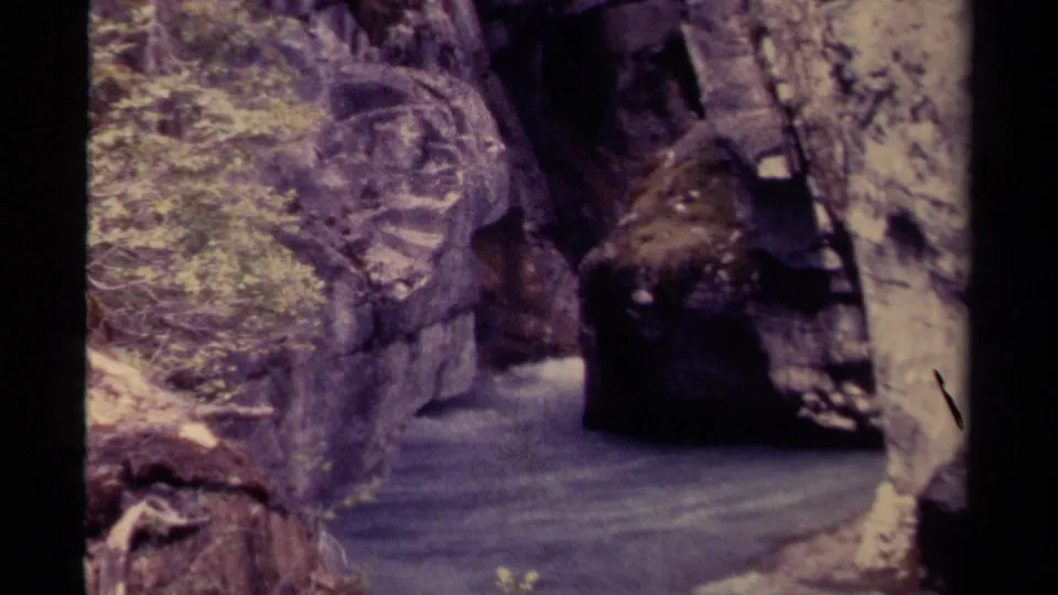 1979 Canadian 8mm frame showing a narrow canyon channel with moving water between steep rock walls.