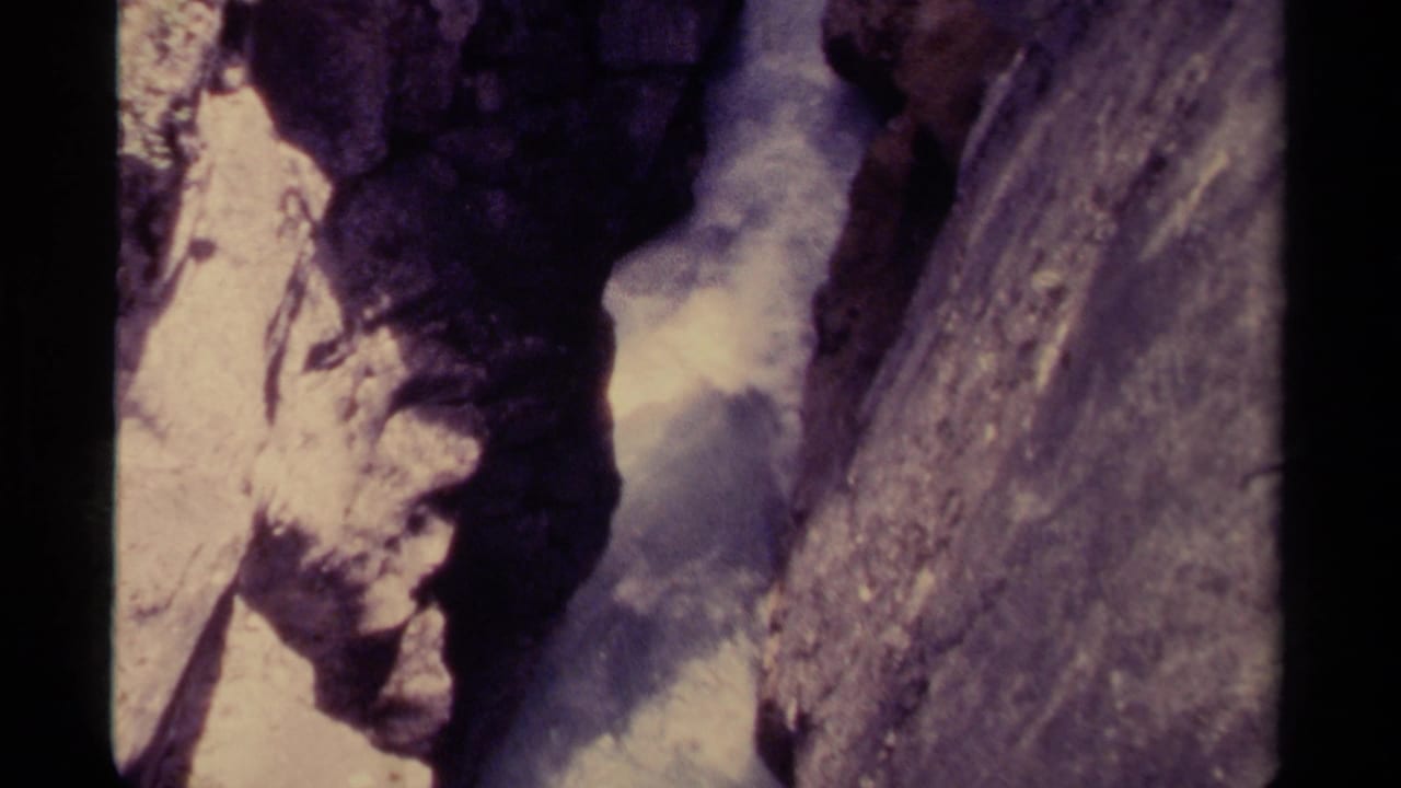 1979 Canadian 8mm frame looking down into foaming water between close canyon rock walls.