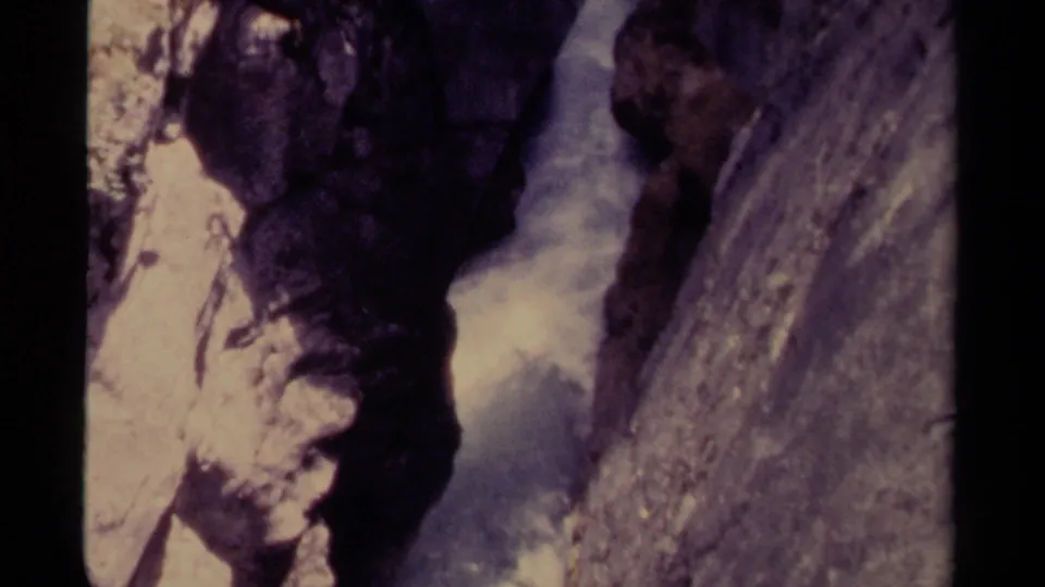 1979 Canadian 8mm frame with rough canyon stone and white water moving through the lower passage.