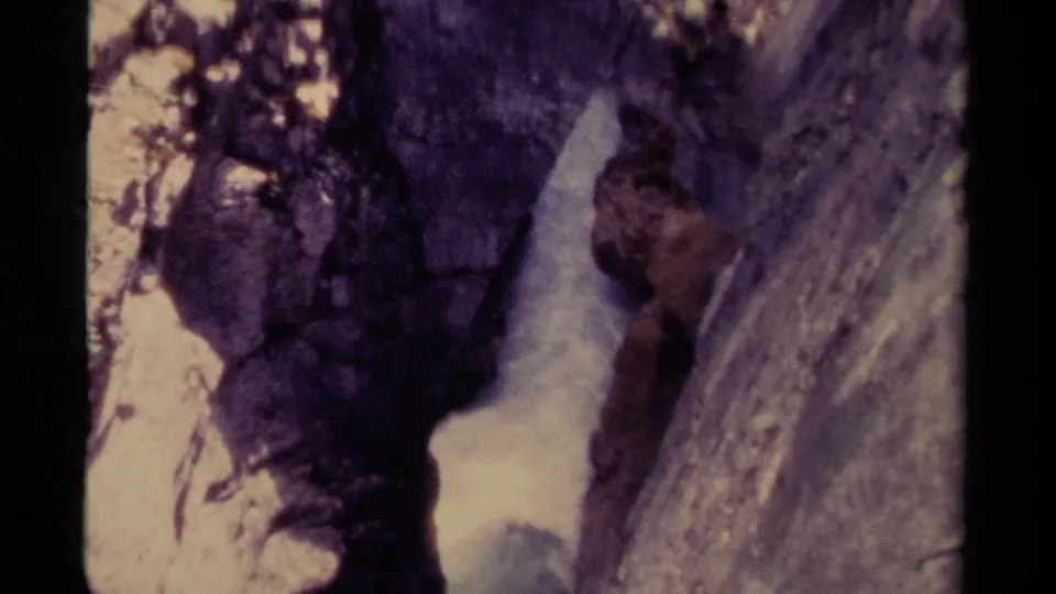 1979 Canada 8mm frame showing white water moving through a narrow rocky ravine with shadowed canyon walls.