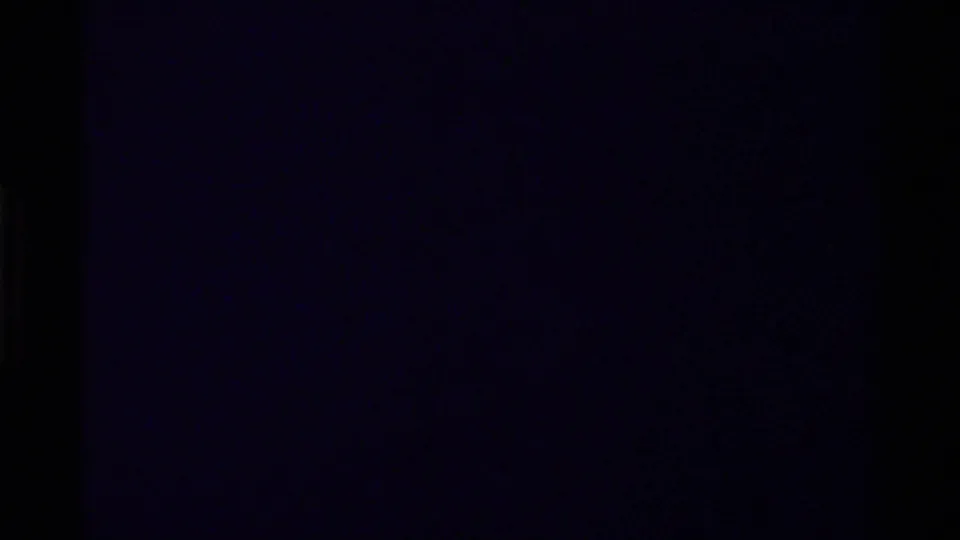 A very dark 8mm frame at the start of the Canada 1979 clip, with little visible detail beyond film grain and color cast.