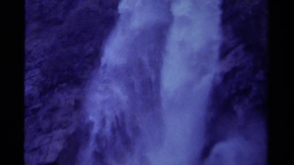1979 Canadian 8mm frame with a waterfall column, drifting mist, and rugged cliff texture.